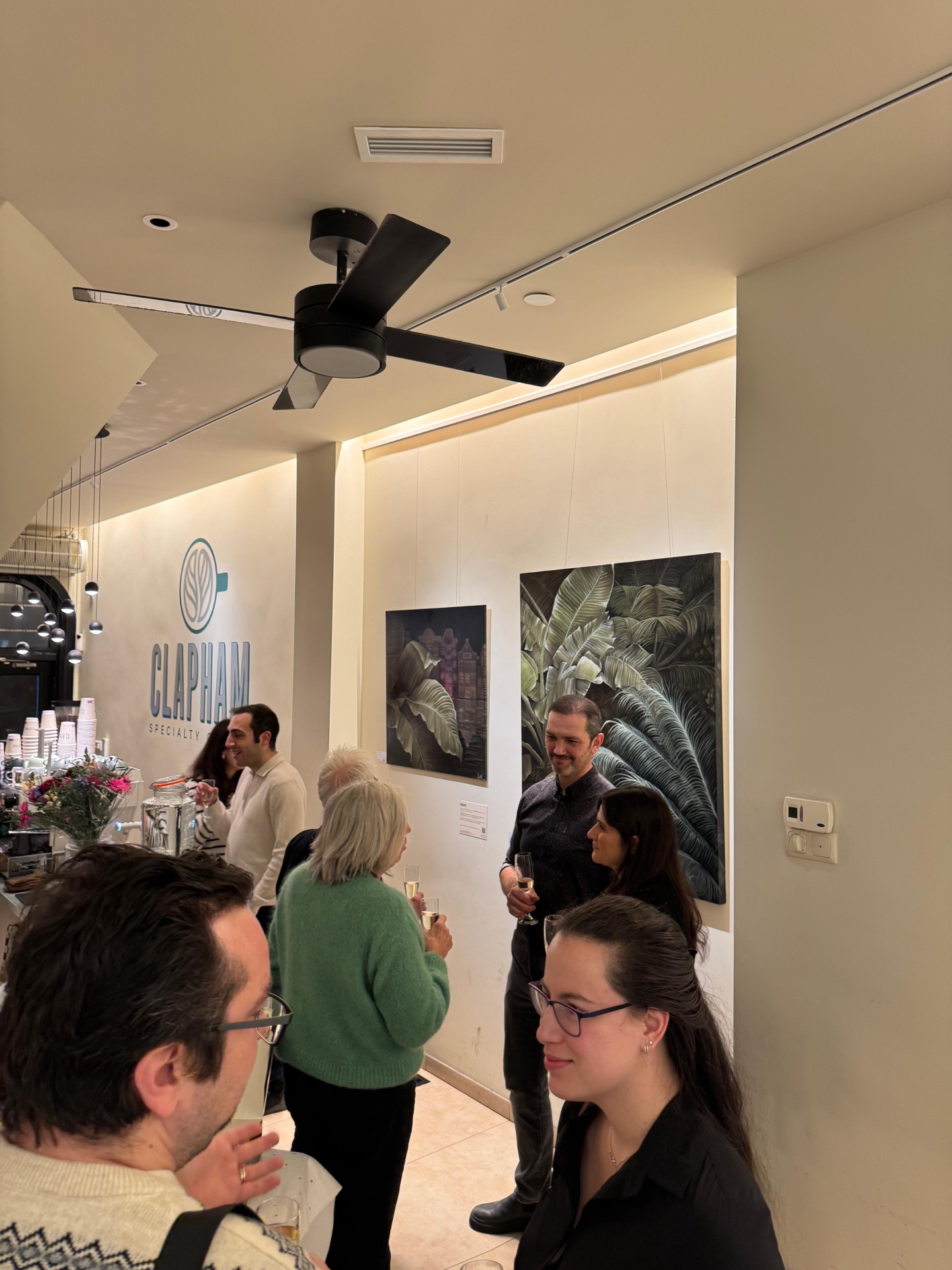 Guests enjoying the exhibition opening at Clapham Specialty Coffee