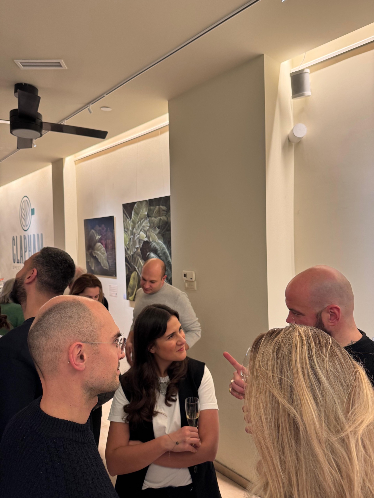Visitors talking during the exhibition opening reception