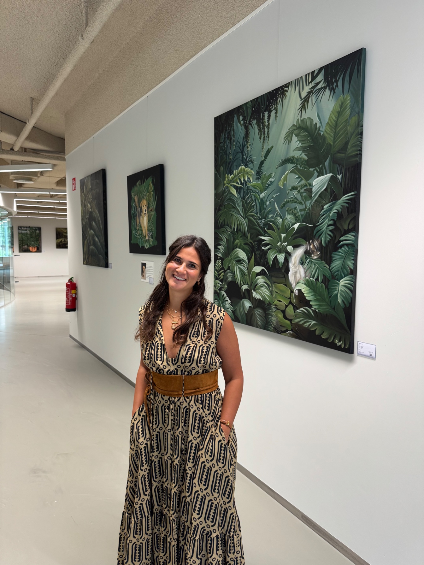 Ecem Naz Ust beside paintings from the Foliage series