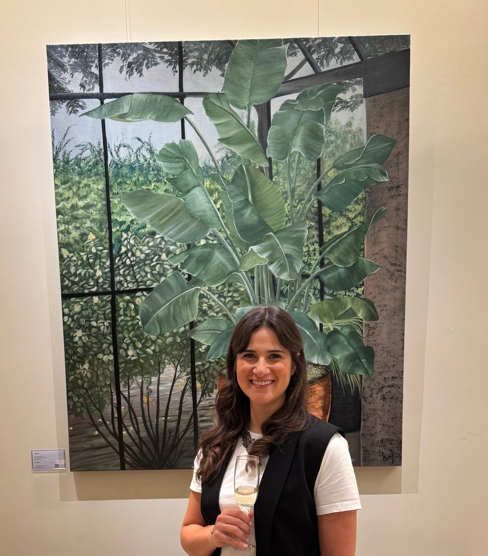 Ecem Naz Ust in front of her large botanical oil painting
